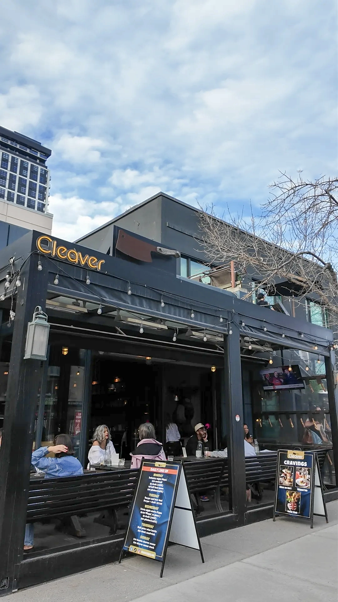 Outdoor patio dining at Cleaver Calgary with handcrafted cocktails and vibrant atmosphere
